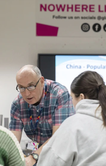 Friendly one-to-one teaching moment between lecturer and students at Glasgow Kelvin College. Friendly one-to-one teaching moment between lecturer and students at Glasgow Kelvin College.
